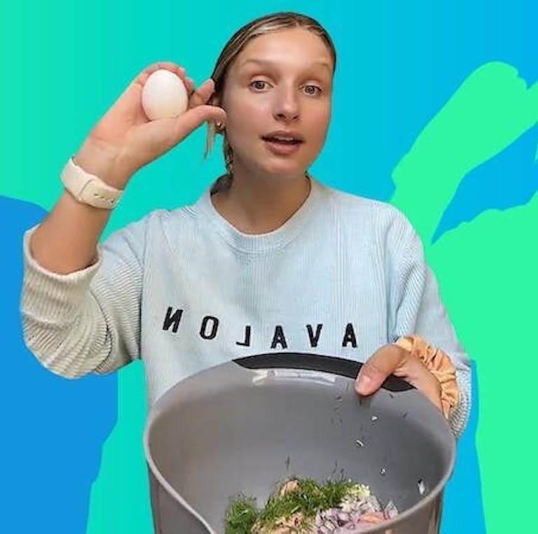 @saltandsagenutrition holding egg up and bowl of ingredients for meatballs on green to blue gradient background Passionfruit Remix