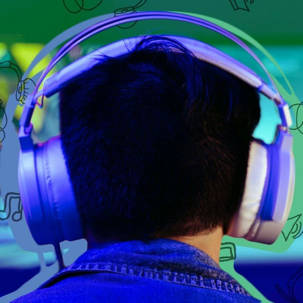 man playing PC games while wearing headphones in front of green to blue gradient headphone icon background Passionfruit Remix