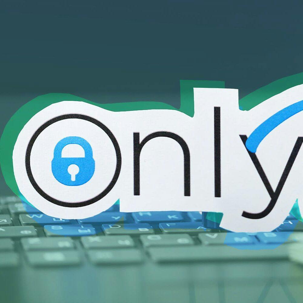 Onlyfans paper logo and dollar bills on black laptop keyboard