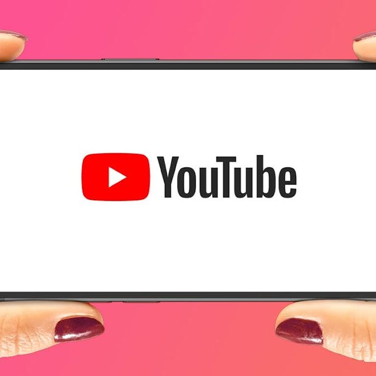 Hands holding phone with youtube