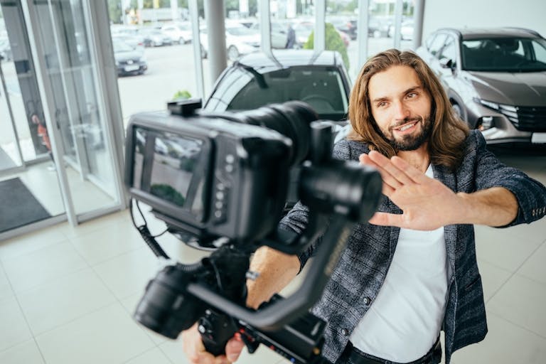 influncer contract - influencer filming themselves looking at a car