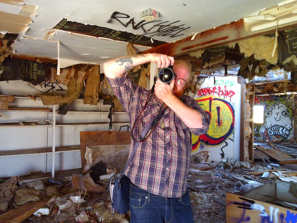 Camp Snap - Photo of a photographer in a burned out gas station
