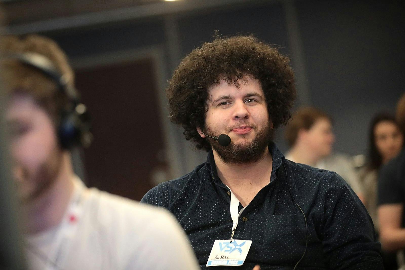 Spikevegeta, a speedrunning live streamer on YouTube, smiling at a convention in 2019.
