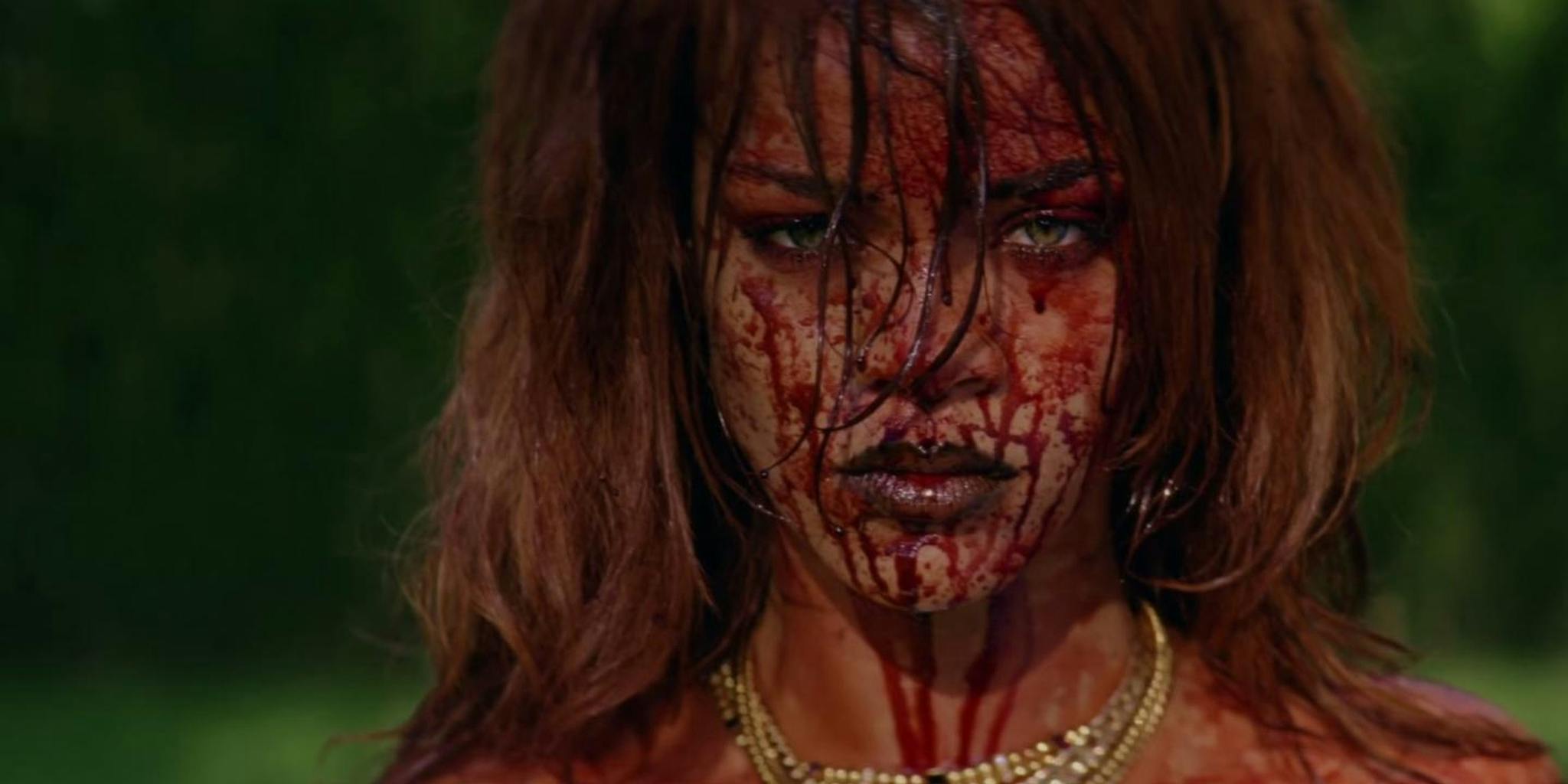 Blood-soaked Rihanna lounges naked on a pile of money in this new video