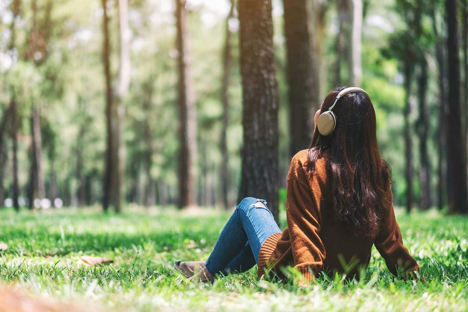 women in forest listening to music