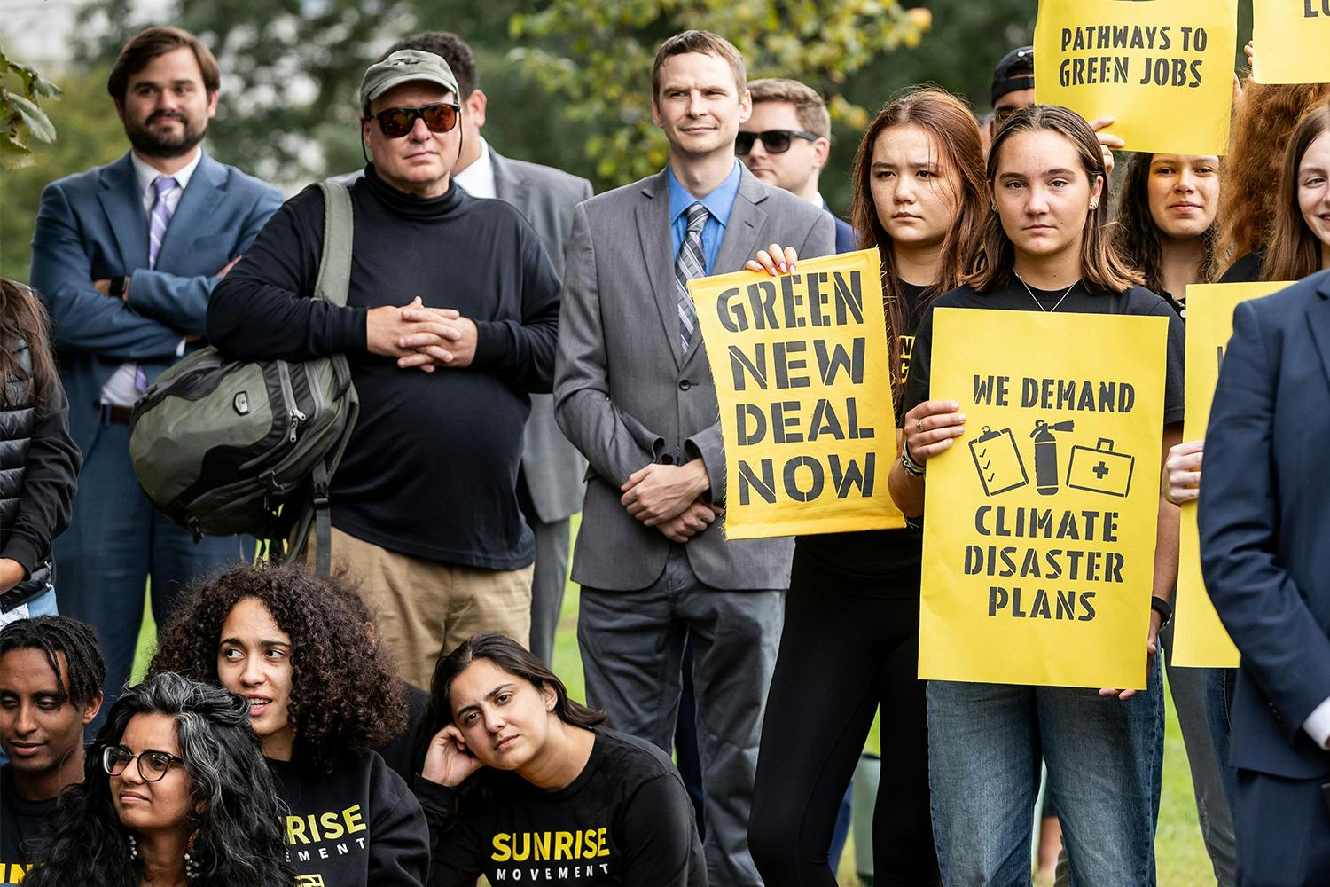 Sunrise Movement members holding climate change protest signs